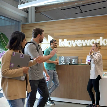 employees-greeting-each-other-in-lobby 1